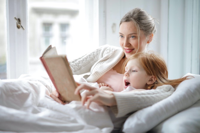 Máma a dcera v posteli s knihou - 